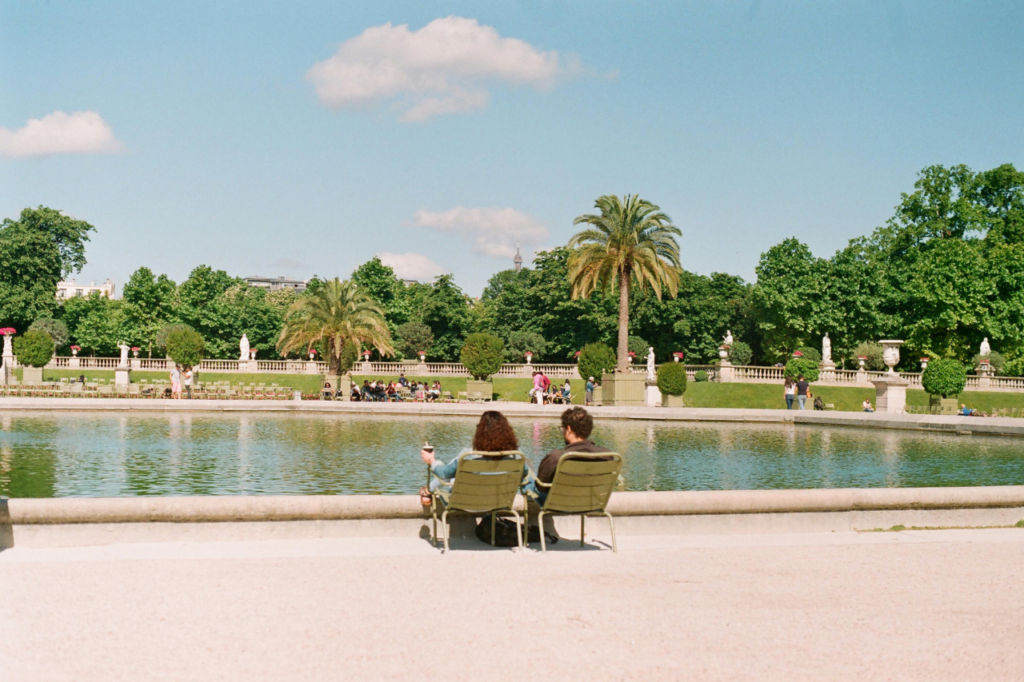 When Is the Best Time to Visit Paris? Relaxing summer day at Luxembourg Gardens with people enjoying the sun by the fountain